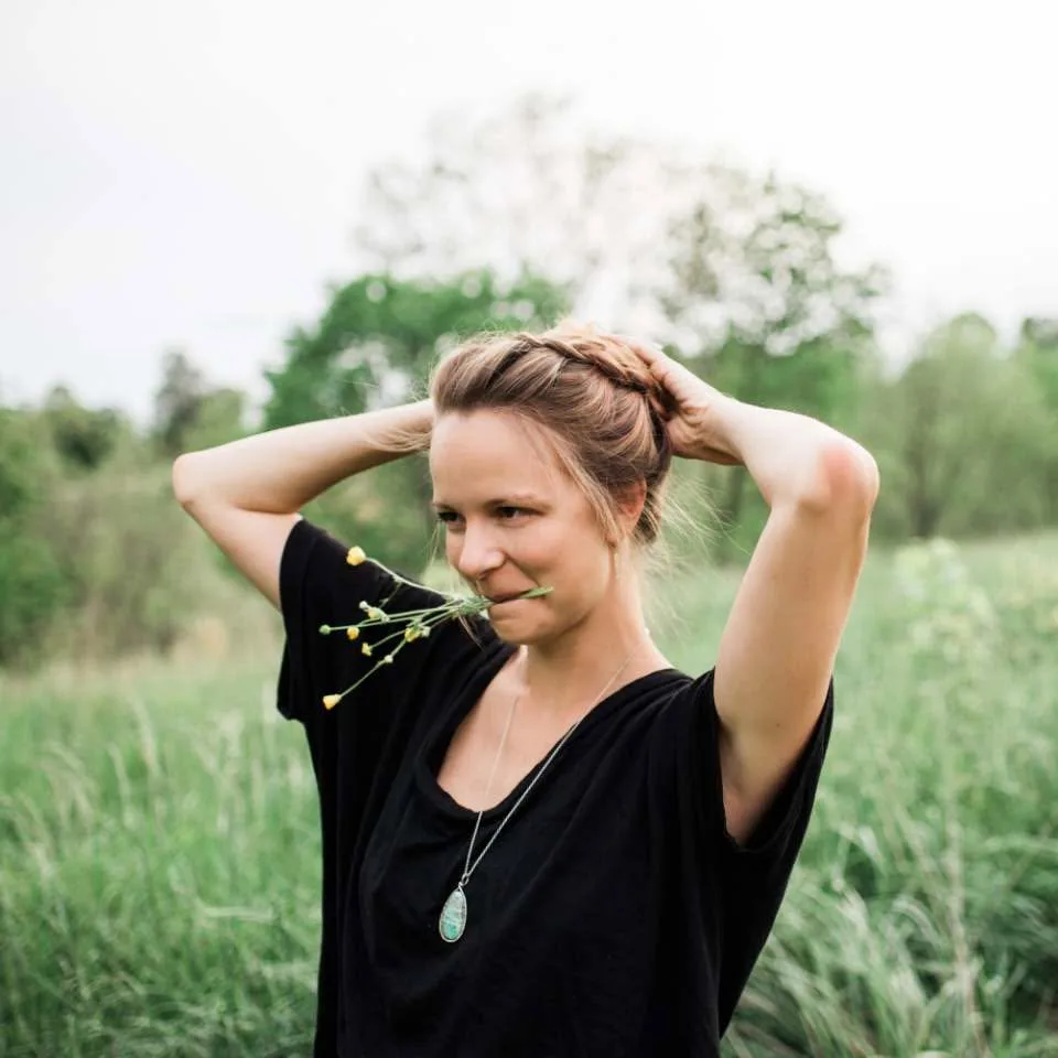 Kate, founder of Village Matcha, in a wildflower field